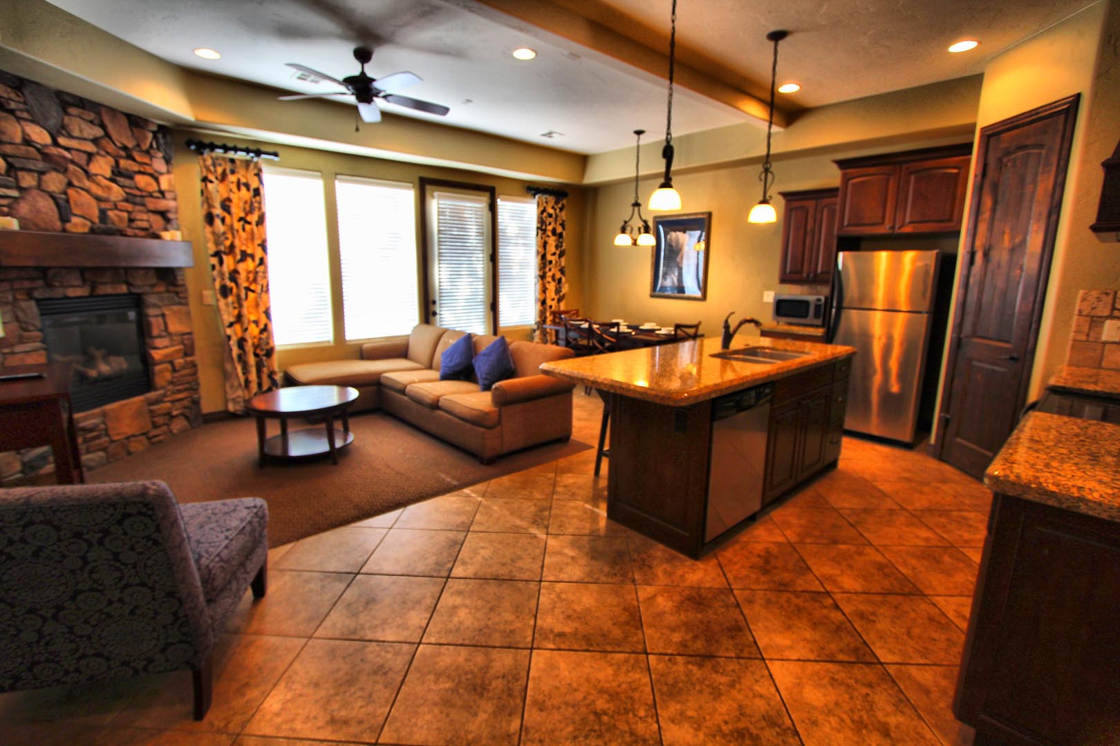A spacious living room and fully equipped kitchen at VRI's Canyon Villas at Coral Ridge in Washington, Utah.